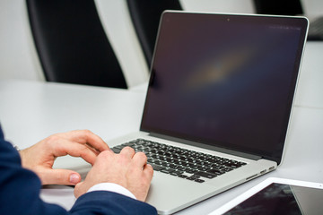 businessman looking for useful information on laptop