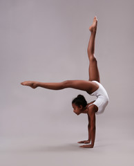 Flexible girl in white leotard
