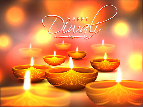 Realistic illuminated lit lamps on blurred bokeh background with stylish lettering Happy Diwali for Festival Of Lights celebration.
