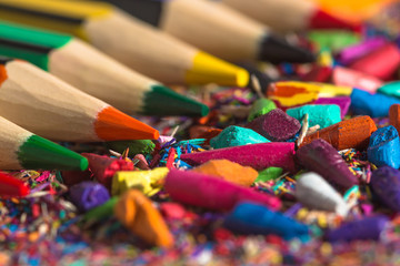 Colourful pencils row with pencil graphite and shavings. Back to school background. Macro photography.
