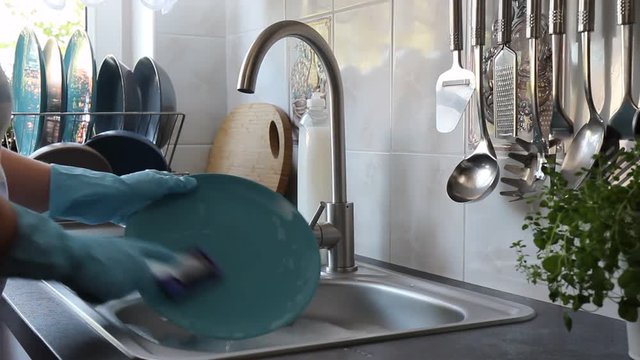 Washing kitchen utensils. Washing plate.