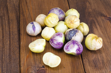 Ripe tomatillo (Physalis, Mexican husk tomato) on wooden table