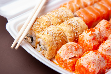 Set of sushi rolls. Delivery of Asian food home. Sushi rolls in thermal box for food