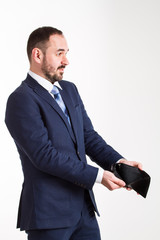 Naklejka premium surprised businessman in blue suit shows an empty wallet