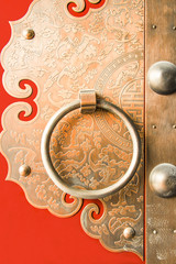 Door knocker and pattern on traditional Chinese red ancient door