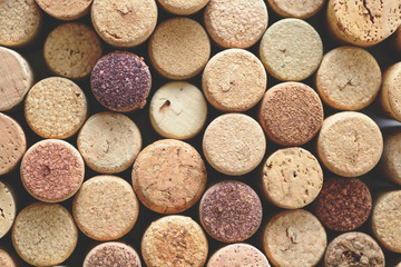 Pile of assorted used wine corks background. Close up top view.