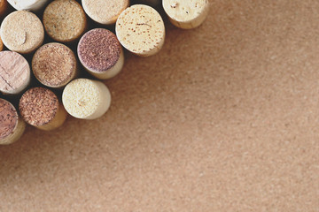 Pile of assorted used wine corks on brown natural craft cork background. Close up top view. Free copy space.