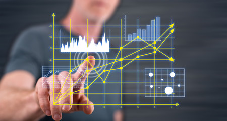 Man touching business charts