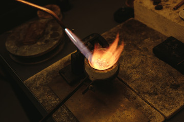 Melting silver in a small crucible - Powered by Adobe