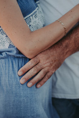 gentle touch of a man's hand on a woman's shoulder