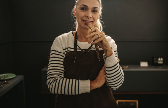 Experienced Female Jeweler In Her Workshop