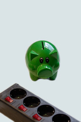 Switchable socket power strip with green piggy bank.Save money with energy savings
