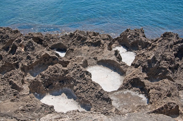 Beautiful natural coast landscape with salt cavities in rocks and turquoise blue water in Mallorca,...
