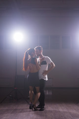 Active happy adults dancing bachata together in dance class