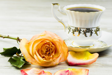 Rose on the background of a cup with an ornament on a white background