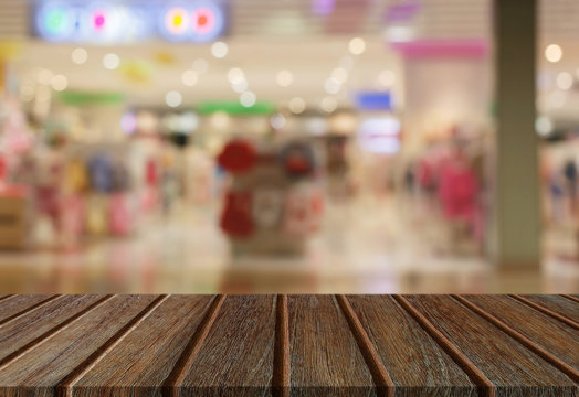 Empty perspective wood plank table top with abstract bokeh light background for montage of your product.