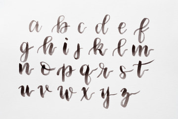 handwritten alphabet on white background. brush lettering craft and calligraphy art practice....