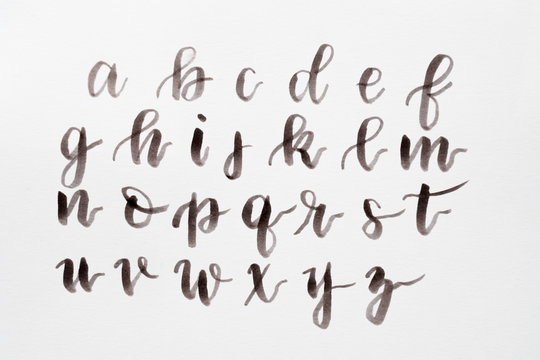 handwritten alphabet on white background. brush lettering craft and calligraphy art practice. artful hobby and creative leisure.