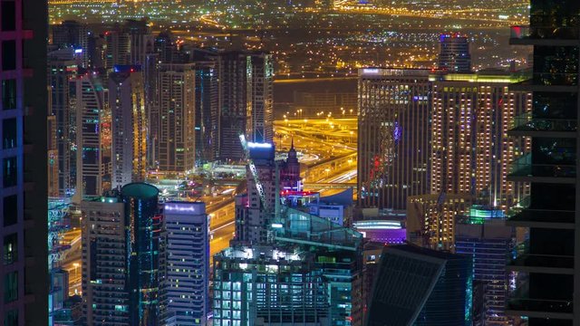 Night cityscape of Dubai Marina time lapse. pan up