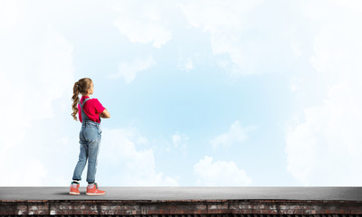 Concept of careless happy childhood with girl looking far away