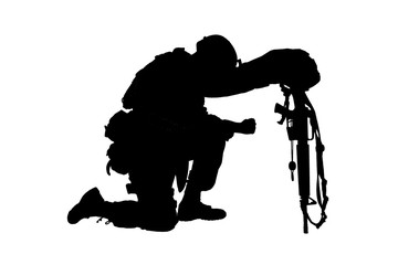 Army soldier in sorrow for fallen comrade, standing on knee, leaning on rifle with helmet and two...