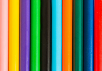 Color pencils in row. Color background. Close up.