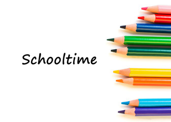 Color pencils isolated on white background. Text schooltime.