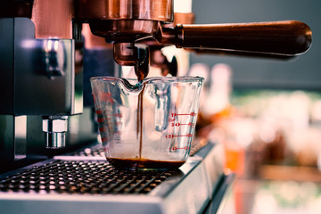 Close up of traditional Espresso Coffee Machine making cup of espresso coffee.