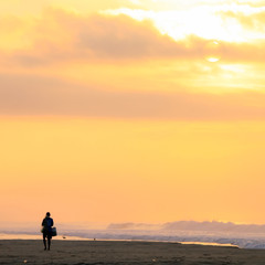 Fototapeta na wymiar Mexican Fisherman Walking on Pacific Ocean Beach at Sunrise.