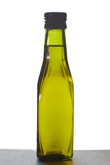 green bottle filled with  Olive oil
