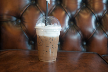 Latte iced coffee on leather sofa
