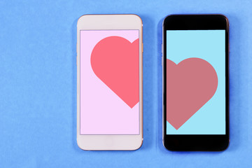 white and black smartphone with a heart on the screen on a colored background