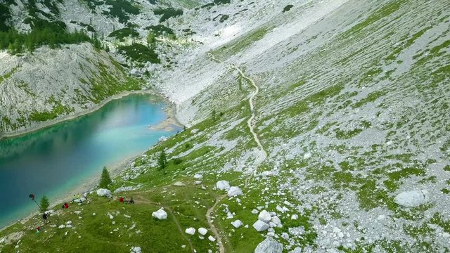 Aerial: Triglav national park in Slovenia, Seven lakes valley. Flying at Ledvica lake. Beautiful valley with lakes between high mountains.