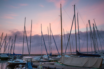 Pastel Sunrise over Boats with Mats Moored in Marina.