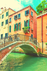 Small bridge and houses by canal in Venice