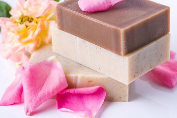 Handmade soap with flower petals on white background