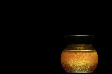 Side view of transparent honey bee in small glass cup