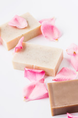 Handmade soap with flower petals on white background