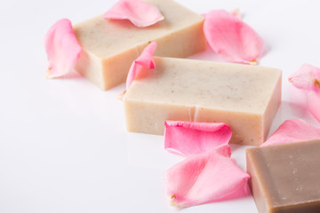 Handmade soap with flower petals on white background