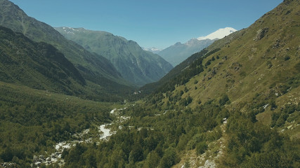 Aerial shooting from flying drone mountain forest. High mountain top view