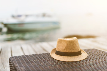 The hat on the seat, which has the sea and sky as the background