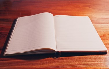 Book on wooden table in bedroom