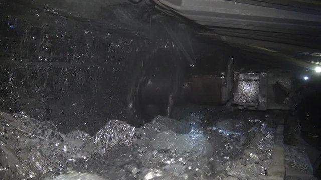 Coal miner produces coal. Coal mining in a real mine