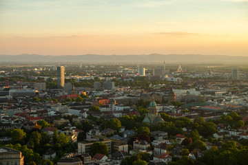 The aerial view of the center of Manheim city from above with hills in the background. Shot during sunset on a summer day from the telecommunication tower.