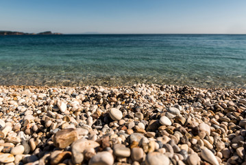 Fototapeta na wymiar Pebble stones on a beach by the Mediterranesan sea