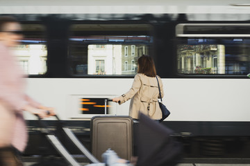 A girl is wating a train in a trian station at Geneva, Switzerland.