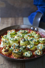Courgette stuffed with ricotta, spinach and peas in tomato sauce