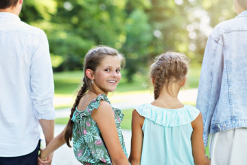 Obraz premium Young family with children having fun in nature
