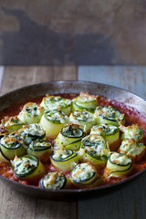 Courgette stuffed with ricotta, spinach and peas in tomato sauce