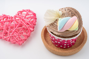 Tasty colorful cupcake isolated on white background, close up.